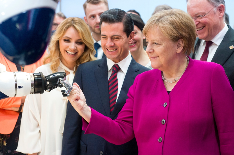 Illustration for article titled German Leader Angela Merkel Still Way Too Friendly With Robots